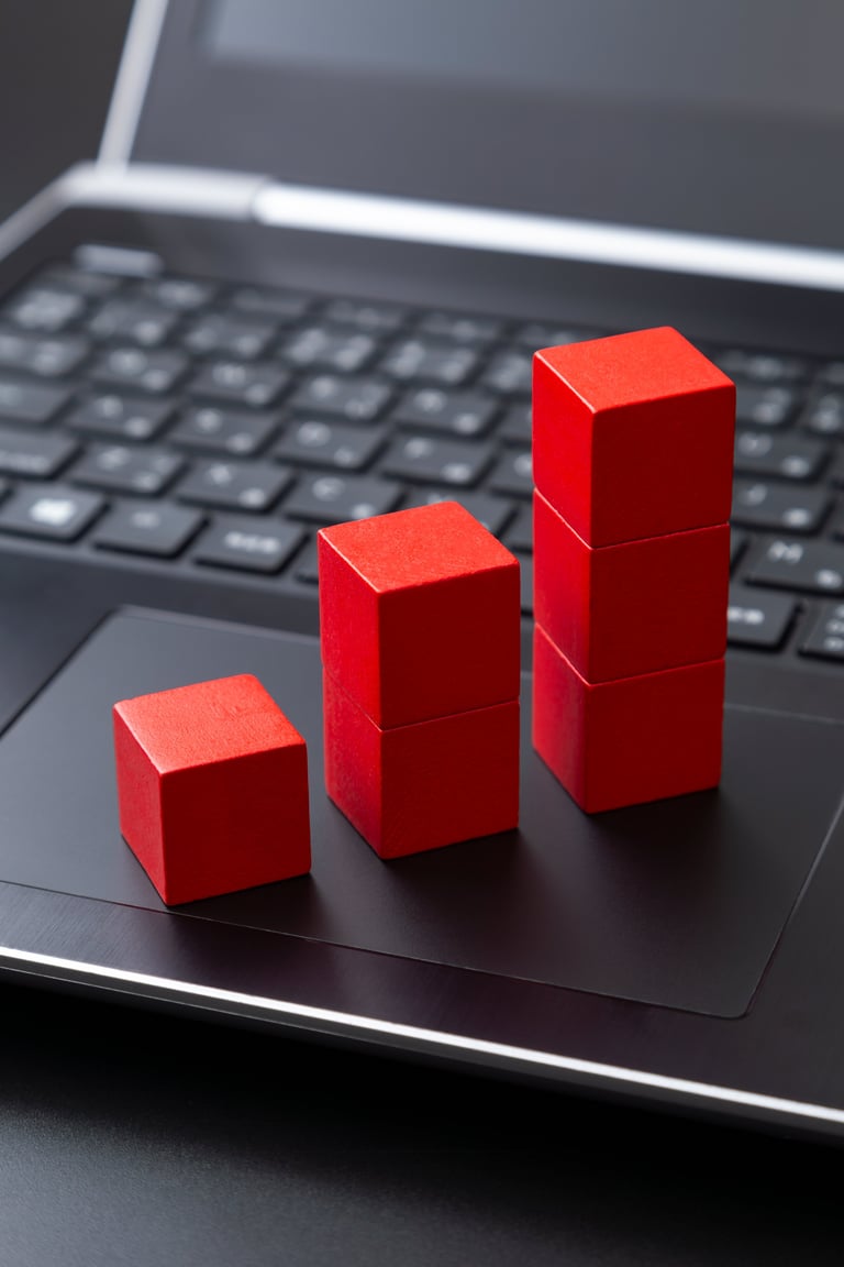 Laptop and building blocks graph representing business analytics